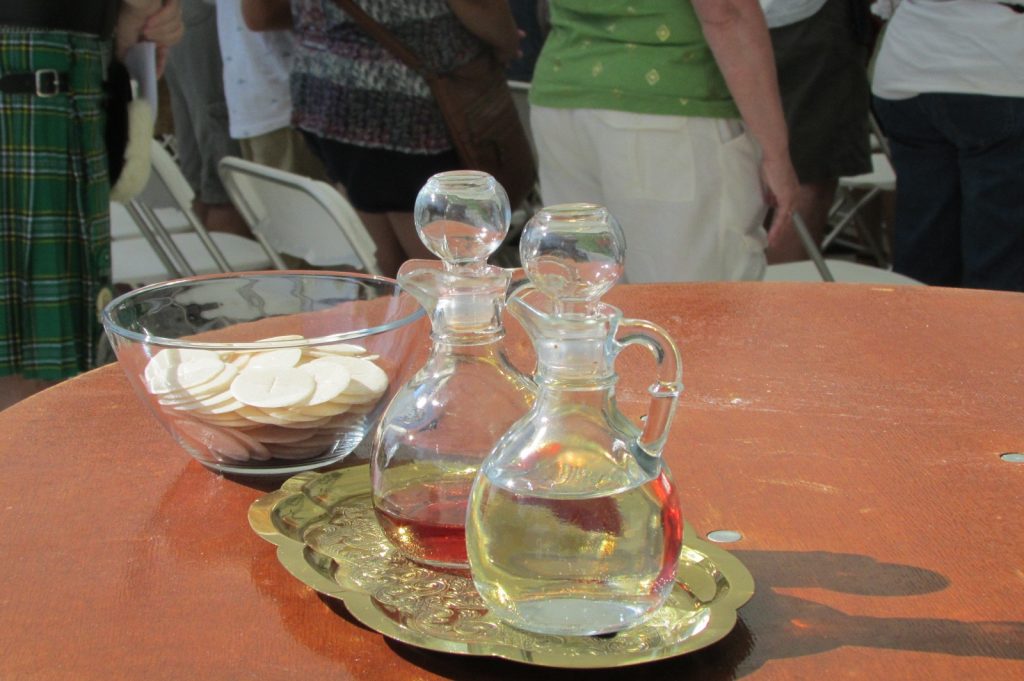 Hosts, wine, and water waiting to be brought forward (CT Photo/Gail Finke)