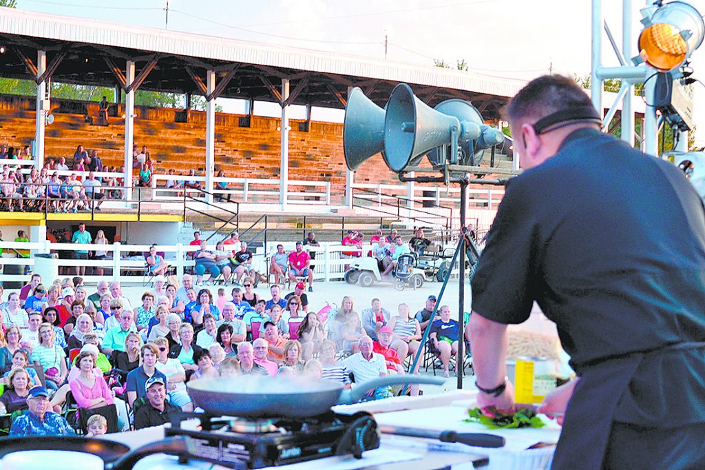 Father Leo Patalinghug, prepares penne pasta with vodka sauce for a crowd at the Mercer County Fair in Celina Aug. 13. It was Father Leo’s first county fair appearance. He launched his cooking ministry shortly after the 9-11 tragedy interrupted a planned trip to France and set in motion a series of events that helped him discern his apostolate to strengthen families and communities around the dinner table. (CT Photo/Steve Trosley)