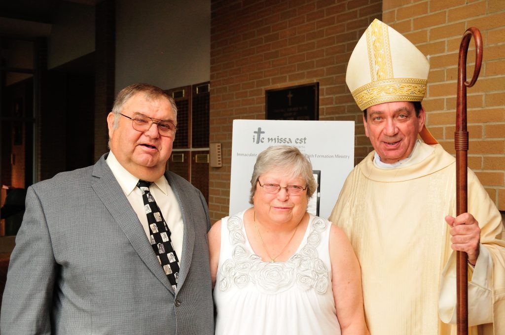 Michael and Lu Zecchini pose for a photo with Archbishop Schnurr after the Golden Jubilee Mass in Dayton. (CT Photo/Jeff Unroe)