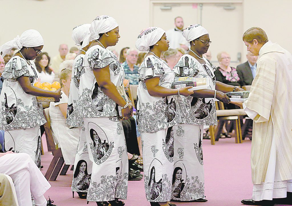Ghanaian members of the congregation present the Gifts during the 50th Anniversary Mass of St. Matthias the Apostle Catholic Church in Cincinnati Sunday, Aug. 6, 2017. (CT Photo/E.L. Hubbard)