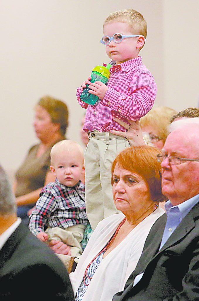 A young boy stands on his parent’s lap during the 50th Anniversary Mass of St. Matthias the Apostle Catholic Church in Cincinnati Sunday, Aug. 6, 2017. (CT Photo/E.L. Hubbard)