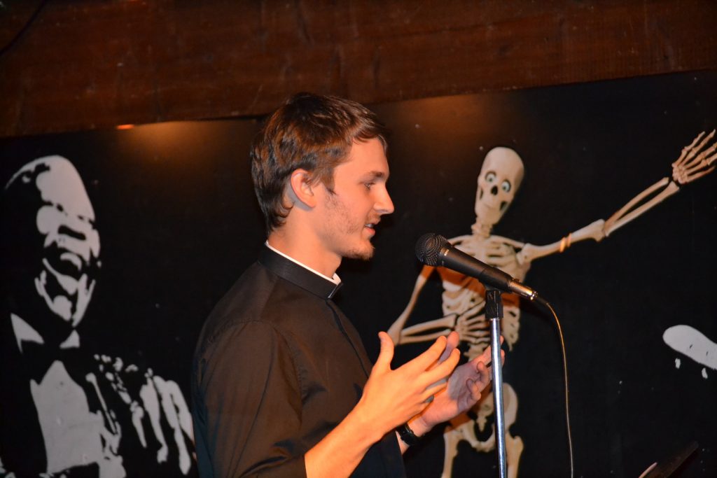 Though it was a stage usually reserved for comics and bands, Seminarian Chris Komoroski delivers his talk on The Power of Silence. (CT Photo/Greg Hartman)