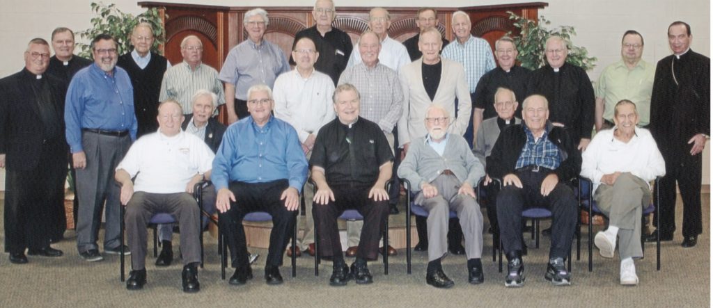 From left to right the Back Row: Frs. Jerome Bishop, Frank Voellmecke, Michael Flaherty, Terry Meehan, Pat Crone, Bob Obermeyer, Mike Pucke, Dave Robisch; Middle Row, Frs. Benedict O'Cinnsealaigh, Bob Schmitz, Bob Goebel, John Wall, Ray Kellerman, Tom Dennemann, Tom King, Mike Leshney, Dennis Dettenwanger, and Archbishop Dennis Schnurr; Front Row: Frs. Tom Fitzsimmons, Clarence Heis, Dale Petreka, Joe Beckman, Carl Wollering, nad Jack Wessling. (Courtesy Photo)