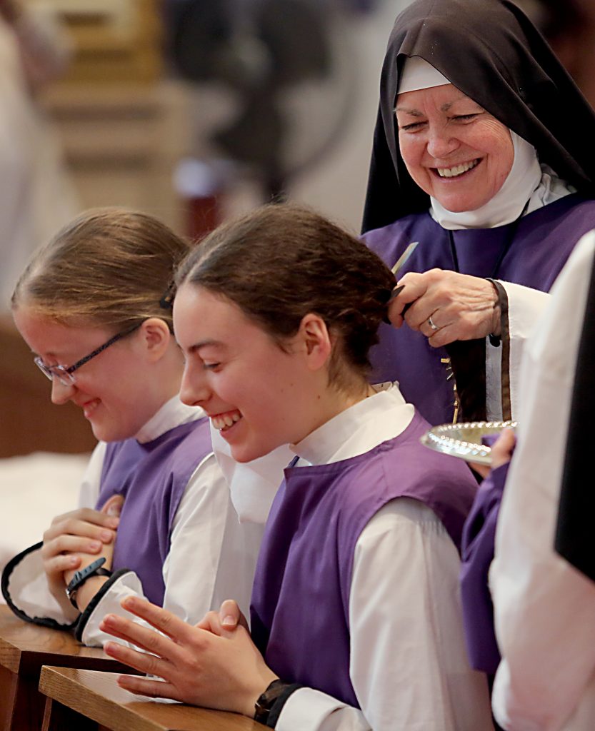 Mother Margaret Mary cuts the hair of postulants Sr. Laura and Sr. Ciara during the Feast of the Presentation of Mary at Our Lady of the Holy Spirit Center in Norwood Tuesday, Nov. 21, 2017. (CT Photo/E.L. Hubbard)