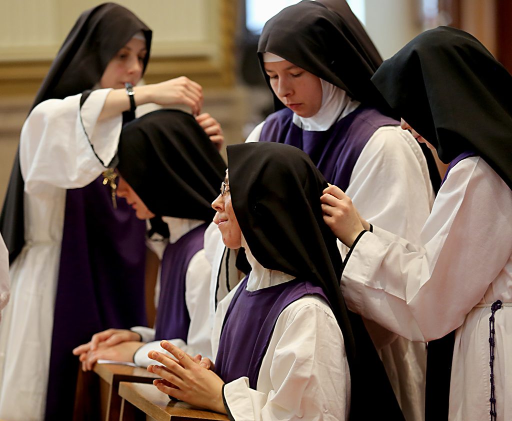 Sisters Antonetta Maria and Mary Consolata receive the black veil, Eucharistic Crucifix, and knotted cincture for the Ceremony of First Profession during the Feast of the Presentation of Mary at Our Lady of the Holy Spirit Center in Norwood Tuesday, Nov. 21, 2017. (CT Photo/E.L. Hubbard)