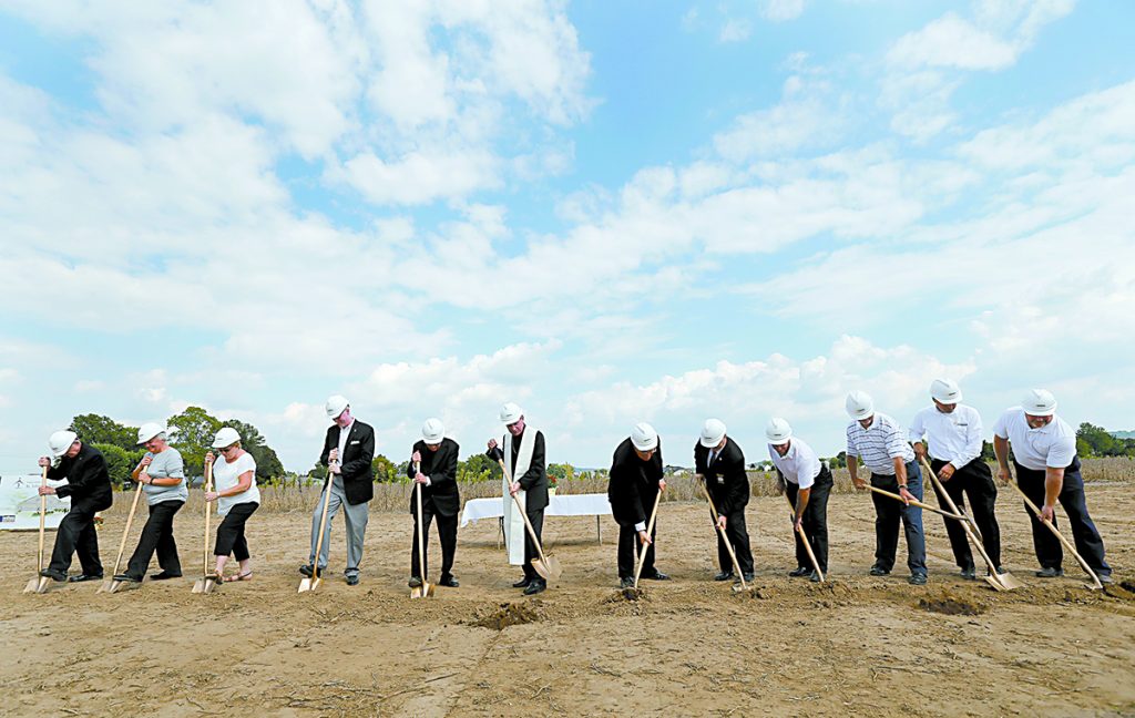 Archbishop Dennis Schnurr, center, with stole, and other church, community, and civic leaders break ground for the new St. John the Baptist Church in Harrison Sunday, Sept. 17, 2017. (CT Photo/E.L. Hubbard)