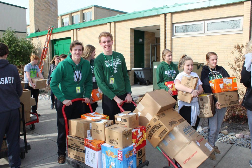 Students at Badin High School in Hamilton collect food for the needy. 