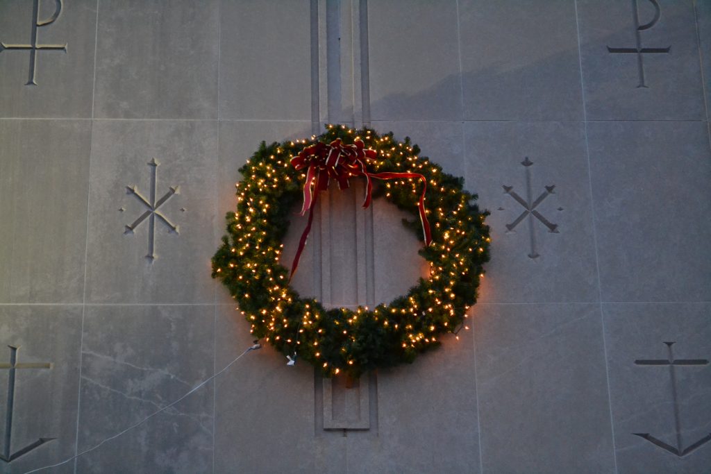 In the darkness a wreath emits light at St Thomas More. (CT Photo/Greg Hartman)