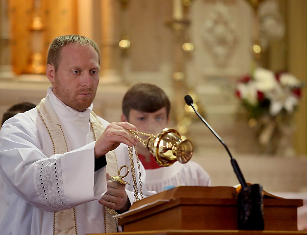 Father Robert Muhlenkamp incenses the Holy Bible during the 150th Anniversary Mass at St. Joseph Church in Hamilton Saturday, Sept. 16, 2017. (CT Photo/E.L. Hubbard)