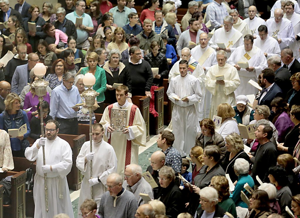 Deacon Jacob Willig carries the Holy Gospel during the Processional for the Chrism Mass at the Cathedral of Saint Peter in Chains in Cincinnati Tuesday, Mar. 27, 2018. (CT Photo/E.L. Hubbard)