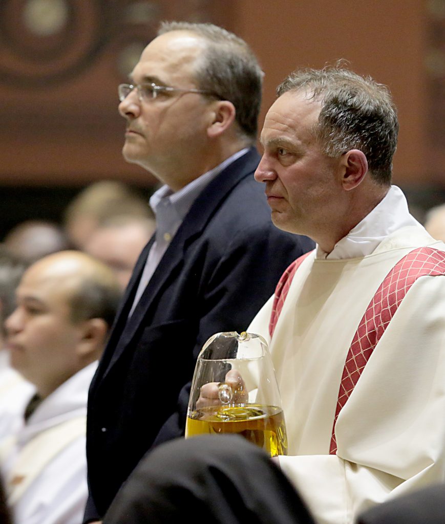 Ross Horvath and Deacon Russ Feldkamp present the Oil of the Catechumens during the Chrism Mass at the Cathedral of Saint Peter in Chains in Cincinnati Tuesday, Mar. 27, 2018. (CT Photo/E.L. Hubbard)