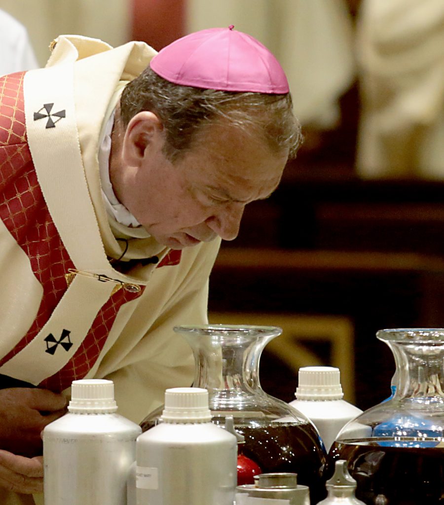 Archbishop Dennis Schnurr breathes on the Sacred Chrism Oil during the Chrism Mass at the Cathedral of Saint Peter in Chains in Cincinnati Tuesday, Mar. 27, 2018. (CT Photo/E.L. Hubbard)