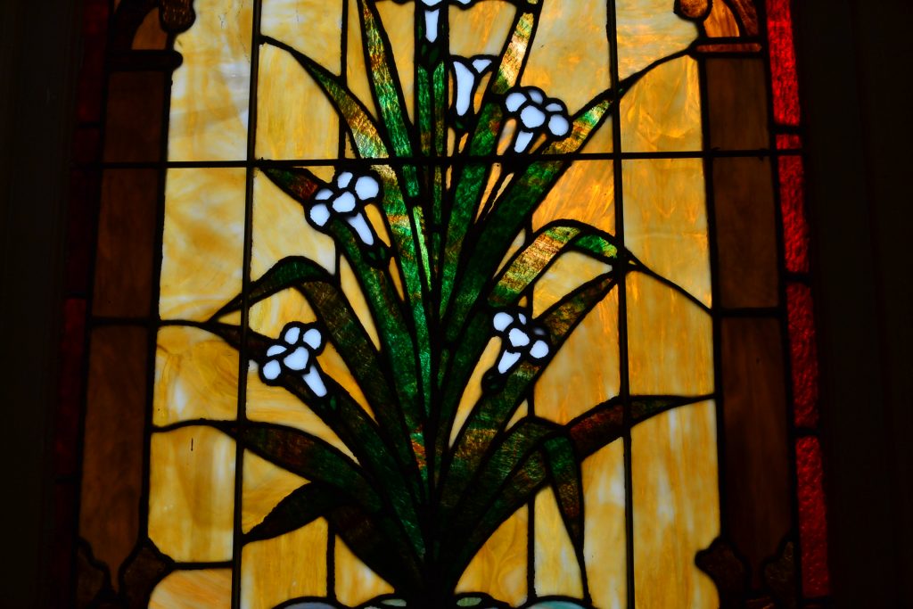 As pilgrims exited the church, a stain glass of an Easter Lily gives the great hope of the resurrection. (CT Photo/Greg Hartman)