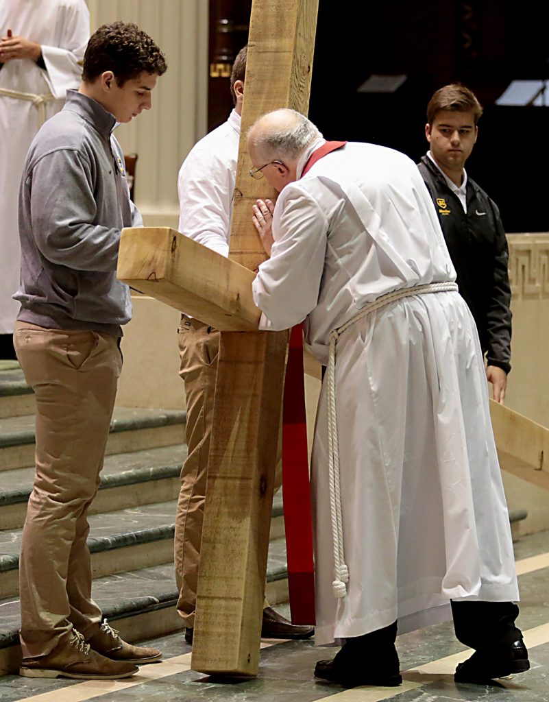 Bishop Joseph Binzer venerates the Holy Cross during the Celebration of the Passion of the Lord at the Cathedral of St. Peter in Chains in Cincinnati on Good Friday, Mar. 30, 2018. (CT Photo/E.L. Hubbard)