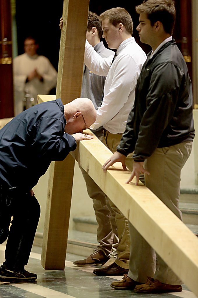 A pilgrim venerates the Holy Cross during the Celebration of the Passion of the Lord at the Cathedral of St. Peter in Chains in Cincinnati on Good Friday, Mar. 30, 2018. (CT Photo/E.L. Hubbard)