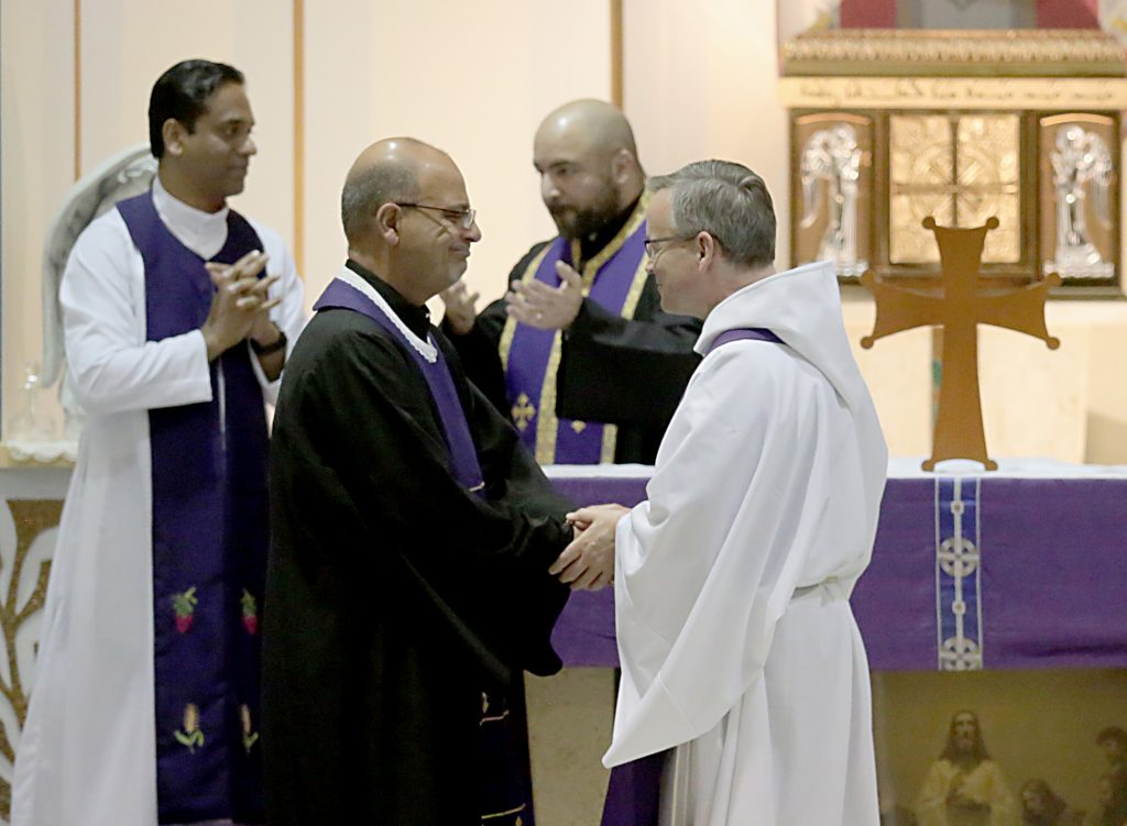 The faith leaders greet each other with the Sign of Peace during the Lenten Prayer Service for Christian Unity and Religious Freedom at St. Anthony of Padua Maronite Catholic Church in Cincinnati Saturday, Mar. 10, 2018. (CT Photo/E.L. Hubbard)