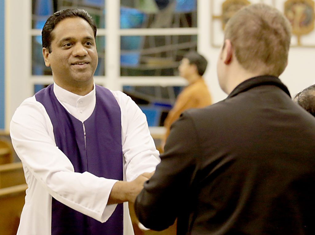 Fr. Jiby Antony Thekkemuriyil, from St. Chavara Syro-Malabar Catholic Mission in Cincinnati, greets a parishioner with the Sign of Peace during the Lenten Prayer Service for Christian Unity and Religious Freedom at St. Anthony of Padua Maronite Catholic Church in Cincinnati Saturday, Mar. 10, 2018. (CT Photo/E.L. Hubbard)