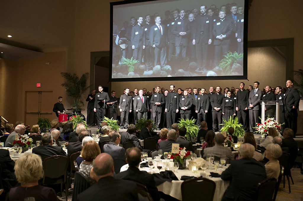 Incoming Rector Father Anthony Brausch, right, and the seminarians of the Athenaeum of Ohio sing an Irish tune for outgoing Rector Father Benedict O’Cinnsealaigh during the Bishop Fenwick Society dinner at the Hilton Cincinnati Netherland Plaza Hotel Friday, May 4, 2018. (CT Photo/ E L Hubbard)