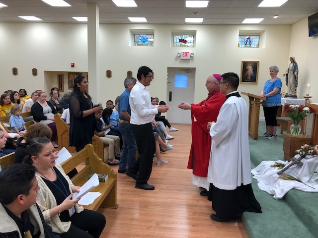 Bishop Joseph Binzer (right) celebrates confirmation for Roberto (center), a deaf Mexican teen studying at St. Rita School for the Deaf. (Courtesy Photo)