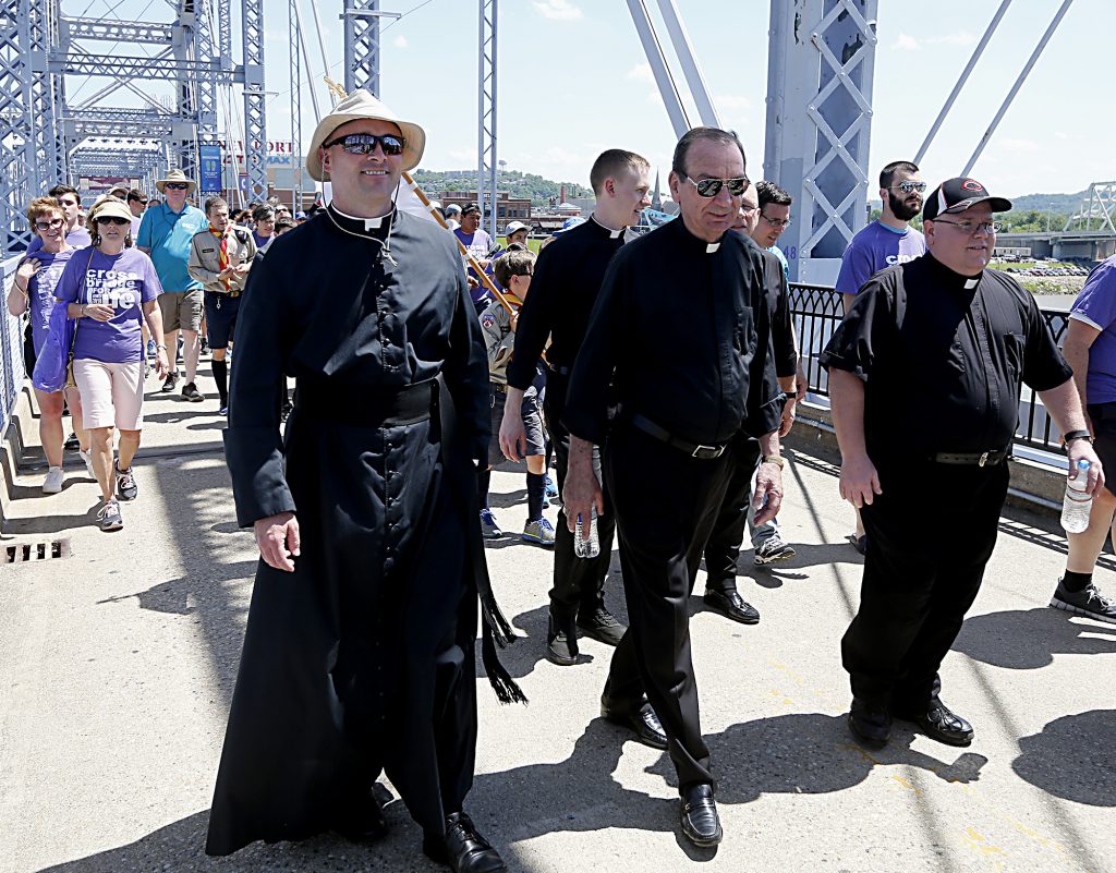 Archbishop Dennis Schnurr, center, crosses the Purple People Bridge with thousands of walkers during the Cross the Bridge for Life celebration on Riverboat Row in Newport, Sunday, June 3, 2018. (CT Photo/E.L. Hubbard)