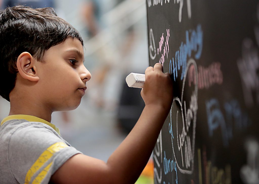 Sahil Furqan, 6, draws his idea of compassion on an art cube during the first Festival of Faiths at the Cintas Center in Cincinnati Sunday, June 24, 2018. (CT Photo/E.L. Hubbard)