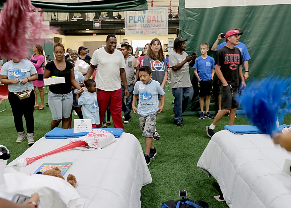 Children look for their beds during the second annual “Day to Dream” event at the P&G MLB Cincinnati Reds Youth Academy in Roselawn Saturday, Aug. 25, 2018. St. Vincent de Paul - Cincinnati and Morris Furniture Company teamed up to provide 50 children in need with a bed of their own. (CT Photo/E.L. Hubbard)