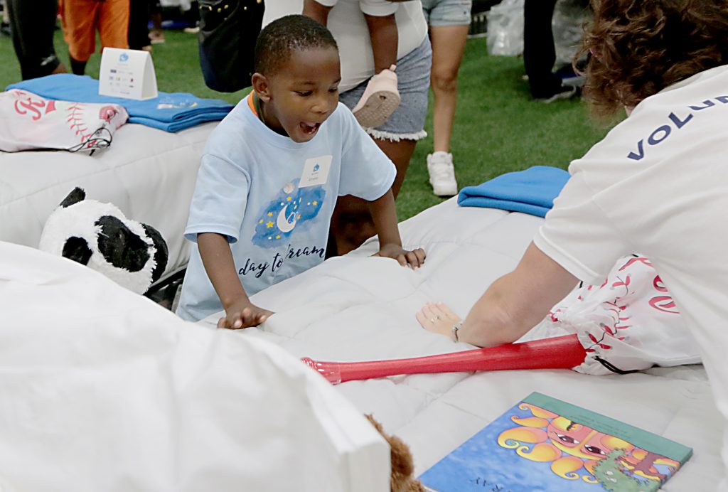 Ahnekko Wills reacts to getting a new bed during the second annual “Day to Dream” event at the P&G MLB Cincinnati Reds Youth Academy in Roselawn Saturday, Aug. 25, 2018. St. Vincent de Paul - Cincinnati and Morris Furniture Company teamed up to provide 50 children in need with a bed of their own. (CT Photo/E.L. Hubbard)