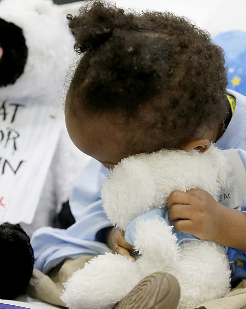 She’Ar McBeth buries her face into her new plush animal during the second annual “Day to Dream” event at the P&G MLB Cincinnati Reds Youth Academy in Roselawn Saturday, Aug. 25, 2018. St. Vincent de Paul - Cincinnati and Morris Furniture Company teamed up to provide 50 children in need with a bed of their own. (CT Photo/E.L. Hubbard)