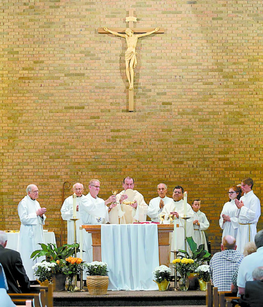 Archbishop Dennis Schnurr and concelebrating priests prepare the Holy Eucharist during the St. Aloysius Parish 150th Anniversary Mass in Shandon Saturday, June 2, 2018. (CT Photo/E.L. Hubbard)