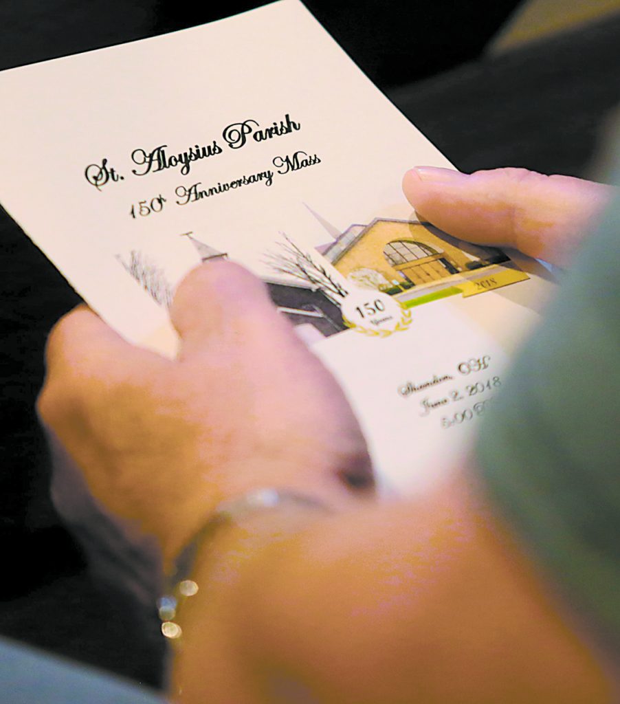 A parishioner holds a program for the St. Aloysius Parish 150th Anniversary Mass in Shandon Saturday, June 2, 2018. (CT Photo/E.L. Hubbard)