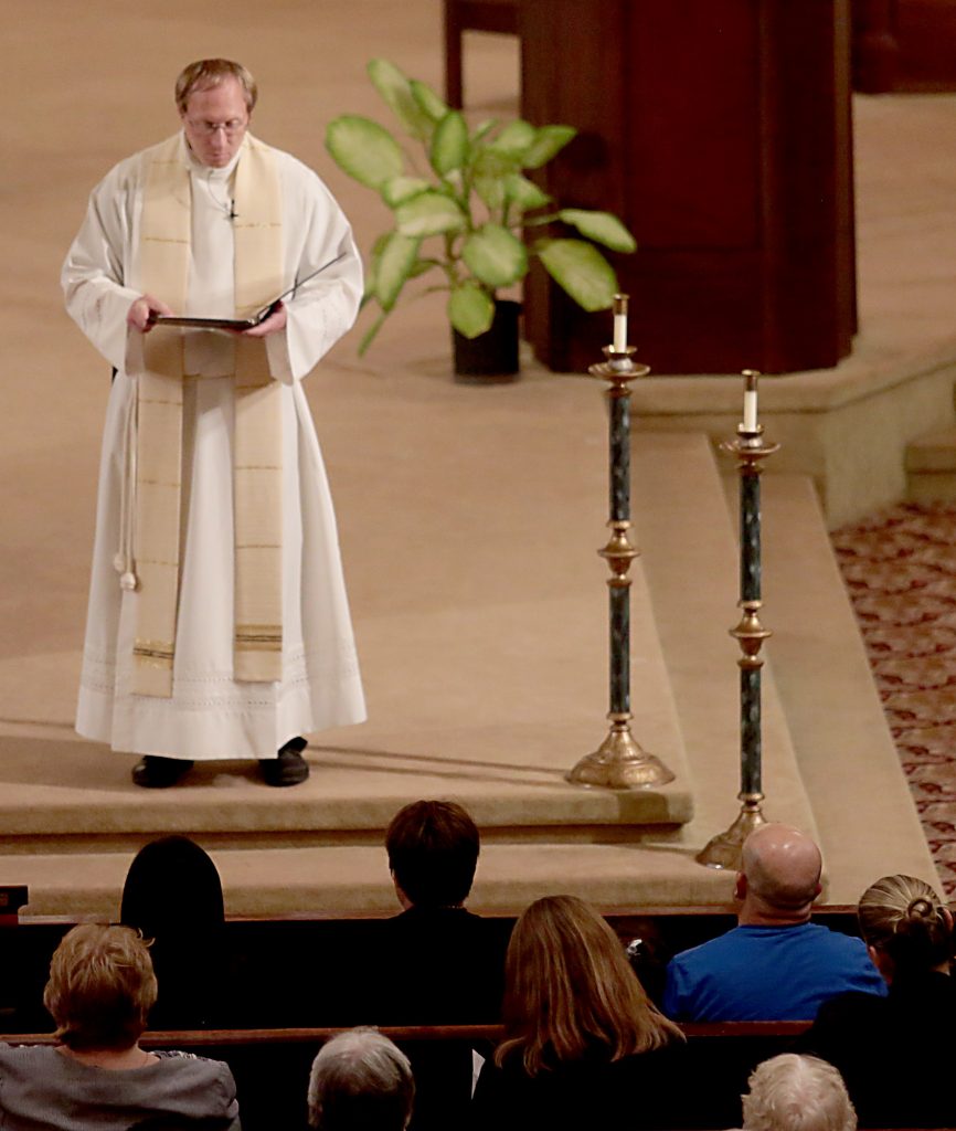 Fr. Rob Muhlenkamp welcomes home Maribel Trujillo Diaz, seated in front row, during a Prayer of Thanksgiving at St. Julie Billiart Parish in Hamilton Tuesday, Sept. 25, 2018. (CT Photo/E.L. Hubbard)