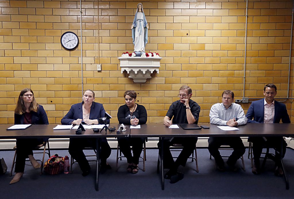 Left to right, Attorneys Emily Brown, Kathleen Kersh, Maribel Trujillo Diaz, Fr. Mike Pucke, Tony Stieritz, and Rev. Alan Dicken speak to the media after the Prayer of Thanksgiving at St. Julie Billiart Parish in Hamilton Tuesday, Sept. 25, 2018. (CT Photo/E.L. Hubbard)
