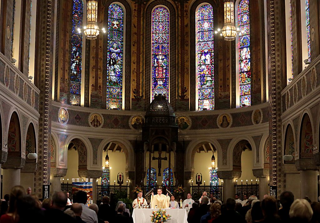 Archbishop Dennis Schnurr prepares the Holy Eucharist for the Mass of Thanksgiving for the 150th Anniversary of the Arrival of the Little Sisters of the Poor in Cincinnati at St. Monica-St. George Parish in Cincinnati Saturday, Oct. 20, 2018. (CT Photo/E.L. Hubbard)