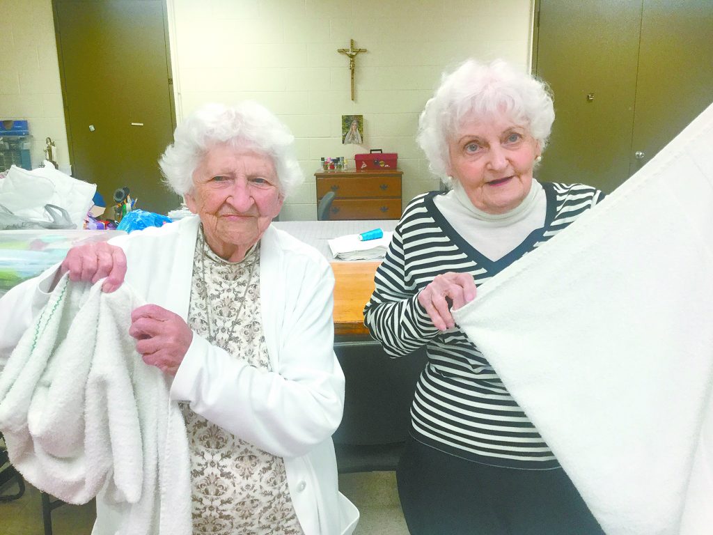 Residents Nancy, left, and Madeline, help fold laundry. (Courtesy Photo)