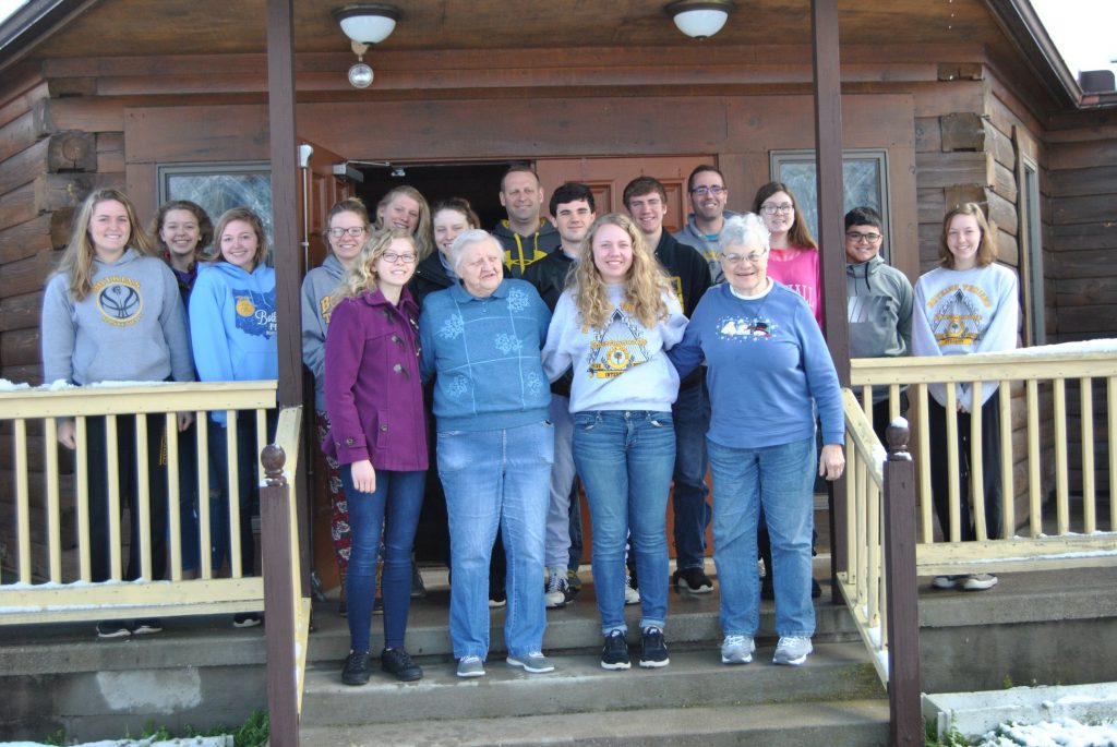 Sisters Marge Eilerman, left, and Angie Kiel post with young people from the Vacation Bible School at Queen of All Saints Parish in Beattyville, Ky. (Courtesy Photo)