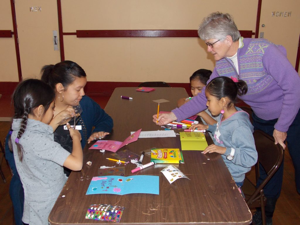 Sister Zoe Brenner helps children make cards for tribal elders. (Courtesy Photo)