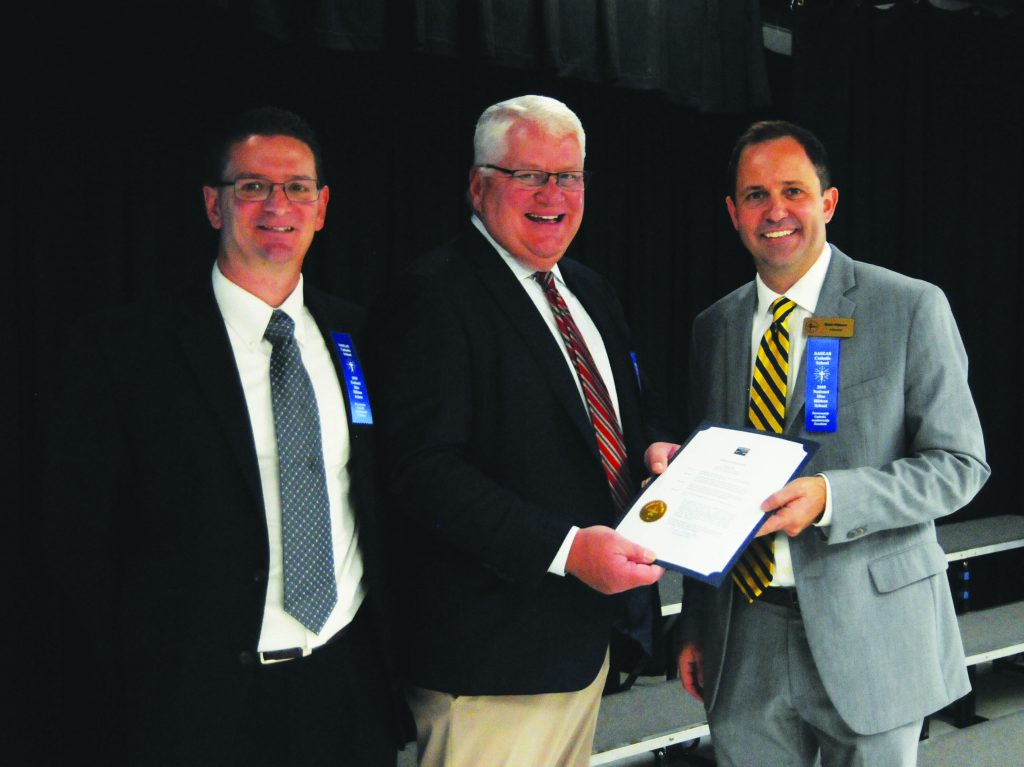 Milford Mayor Fred Albrecht presents a proclamation recognizing St. Andrew-St. Elizabeth Ann Seton Catholic School's designation as a Blue Ribbon School of Excellence to Principal Mark Wilburn and Assistant Principal Nick Grieco( on Friday, Oct. 12. (CT Photo/David A. Moodie)