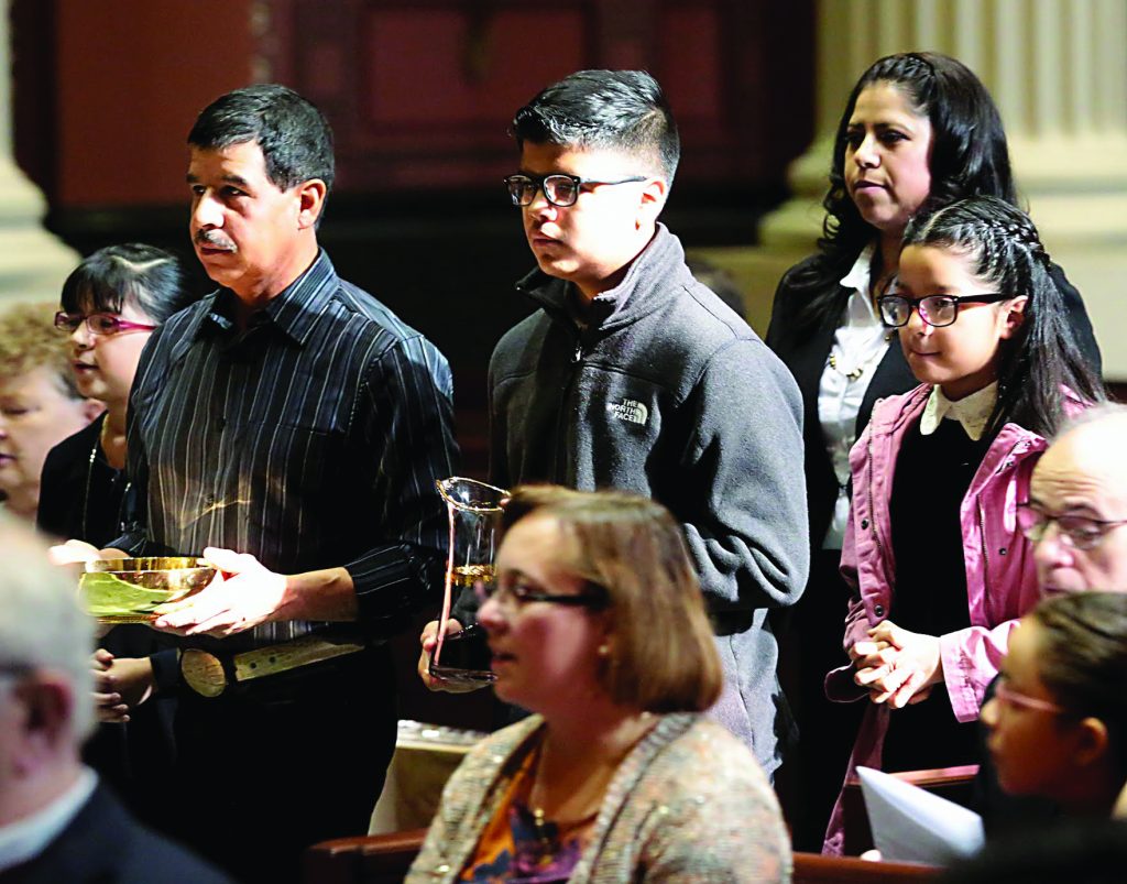 The Davila-Lopez family carries the Gifts during the Misa de Graduacion en Catequesis Camina Con Cristo at Saint Peter in Chains Cathedral in Cincinnati Saturday, Nov. 3, 2018. (CT Photo/E.L. Hubbard)