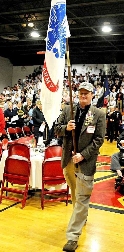Retired Army Colonel Steve Koenig carries the Army flag during the opening processional of La Salle High School's 5th Annual Veteran Appreciation Day on Tuesday, Feb. 12. Veterans from the greater Cincinnati area were recognized by the school's student body and staff for their service to United States of America. (CT Photo/David Moodie)