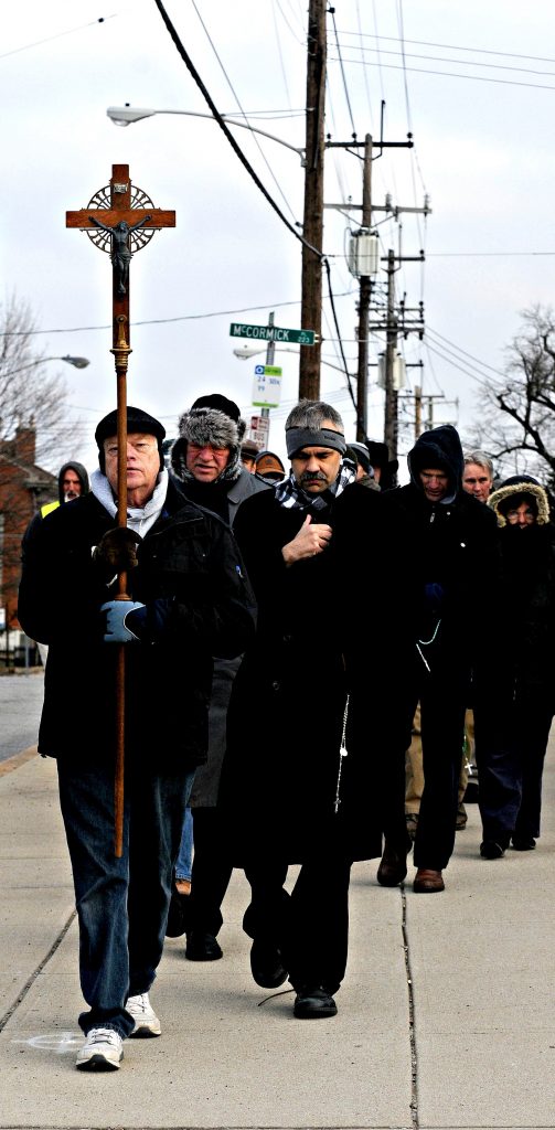 Fred Sume leads members of "God's Helpers of Precious Infants" from Holy Name Church to Planned Parent Hood's Auburn Ave. Surgical Center Sautrday, Feb. 16. The group has a prayer vigil for the end of abortion in front of the center every first, third and fourth Saturday of the month. The vigil ‌includes mass at Holy Name Church, procession to Planned Parenthood and the praying of the rosary in front of the center. The group meets at St. Theresa Avila Church on the second Saturday of the month and has a similar vigil at Planned Parenthood's Western Hills Health Center. (CT Photo/David A. Moodie)