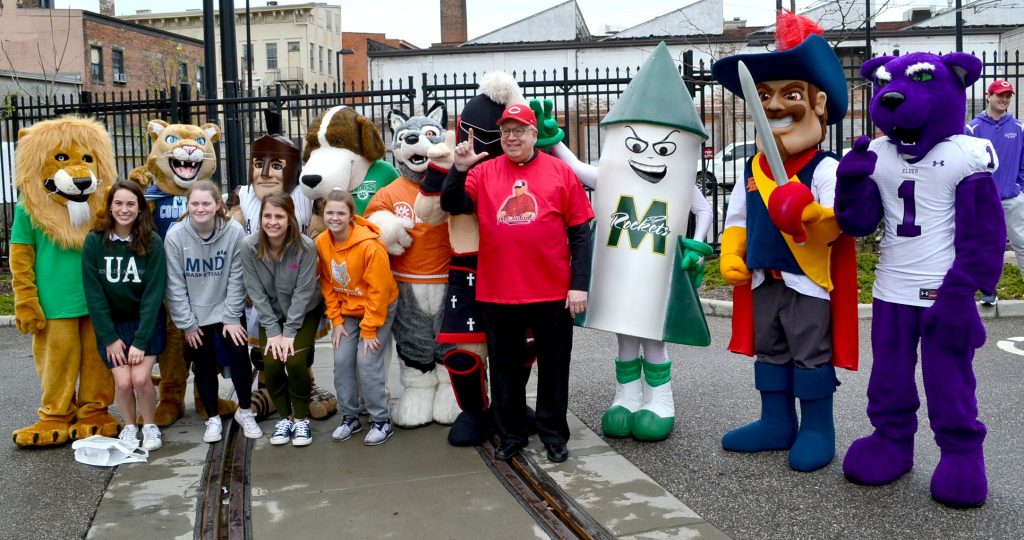 Mascots from various Archdiocese of Cincinnati Catholic High School pose for a picture with Bishop Joseph Binzer before the 2019 Findlay Market Opening Day Parade. (CT Photo/Greg Hartman)