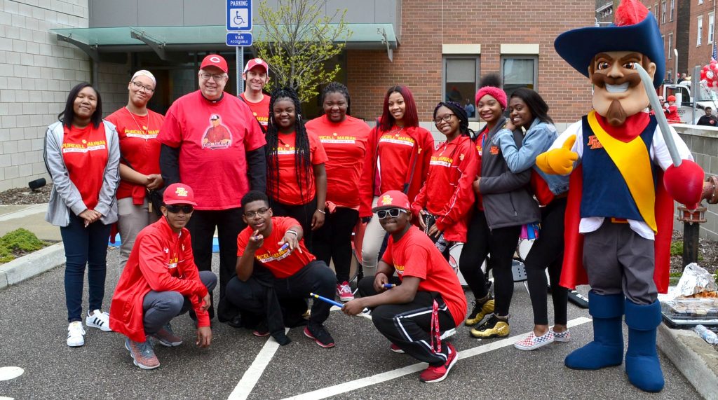 Bishop Binzer is with the Purcell Marian Drum Line before the start of the 2019 Findlay Market Opening Day Parade. (CT Photo/Greg Hartman)