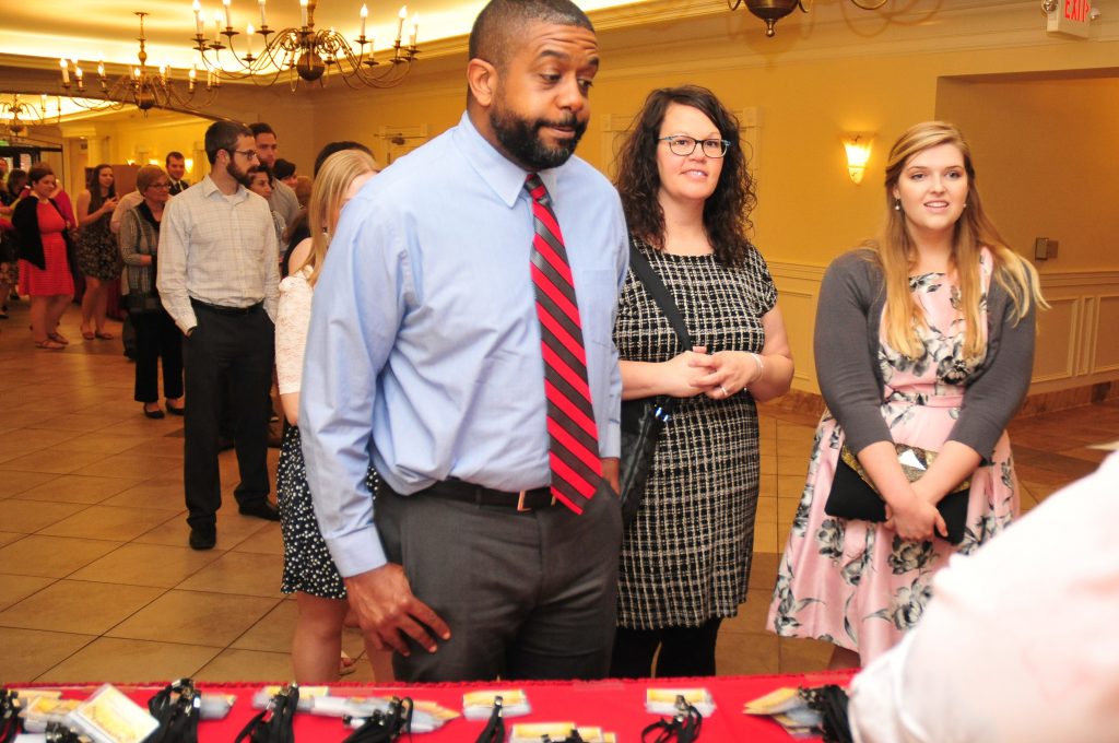 Eric Ramsey, Carroll HS, Lara Ramsey CHS, Mary Kate Caserta CHS, all get checked into the dinner. (CT Photo/Jeff Unroe)
