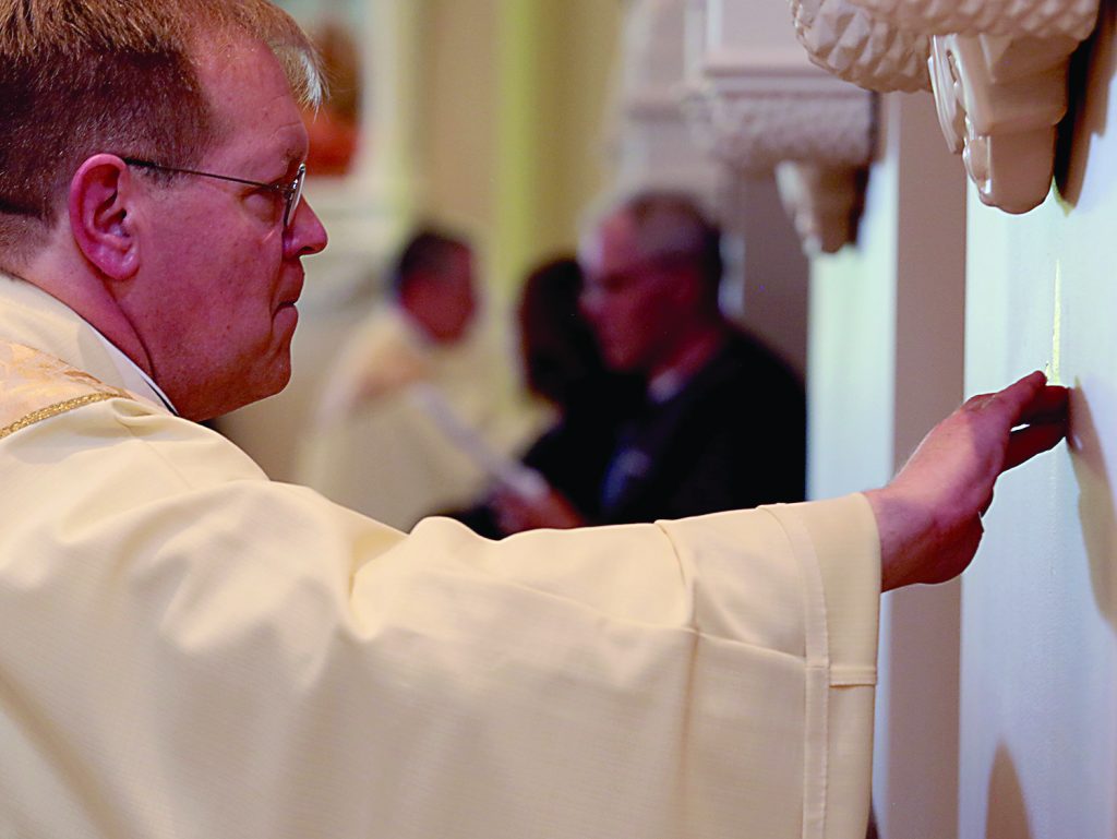 Father Jeffrey Kemper annoints the walls during the dedication of St. John the Baptist Church in Harrison Saturday, June 1, 2019. (CT Photo/E.L. Hubbard)