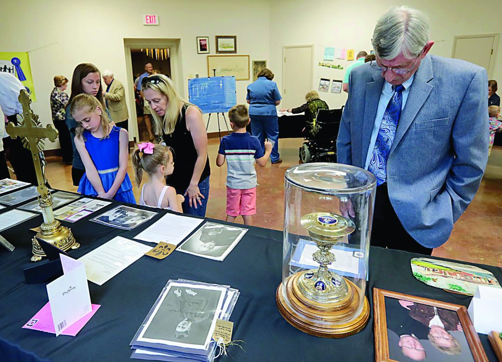 Parishioners examine historical items during the 75th Anniversary Mass of St. Antoninus Parish in Cincinnati Sunday, June 2, 2019. (CT Photo/E.L. Hubbard)