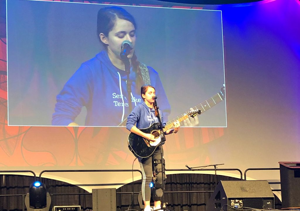 Miley Azbill of Kettering sings at the National Catholic Youth Conference in Indianapolis.