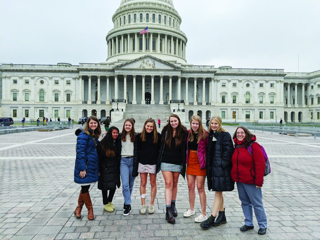 Saint Ursula counselor Laura Roman, Anna Ehrsam, Charlotte Maliborski, Alivia Hyland, Abigail Gold, Eleanore Bender, Kaya Stone and SUA teacher Joanne Elsbrock