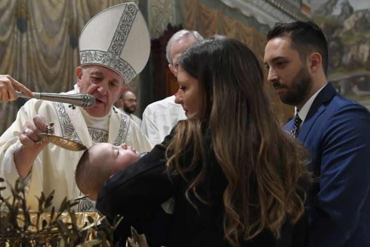 Pope Francis baptizes a child in the Sistine Chapel on Jan. 12, 2020. Credit: Vatican Media