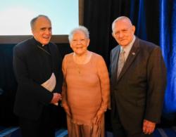 Cardinal Daniel N. DiNardo of Galveston-Houston poses with Gene Kranz, right, former flight director for Apollo 11, and his wife, Marta, during the 2019 Archdiocese of Galveston-Houston Prayer Breakfast in Houston July 30. Gene Kranz, who served as the event's speaker, is a parishioner at Shrine of the True Cross Catholic Church in Dickinson, Texas, near Houston. (CNS photo/James Ramos, Texas Catholic Herald) 