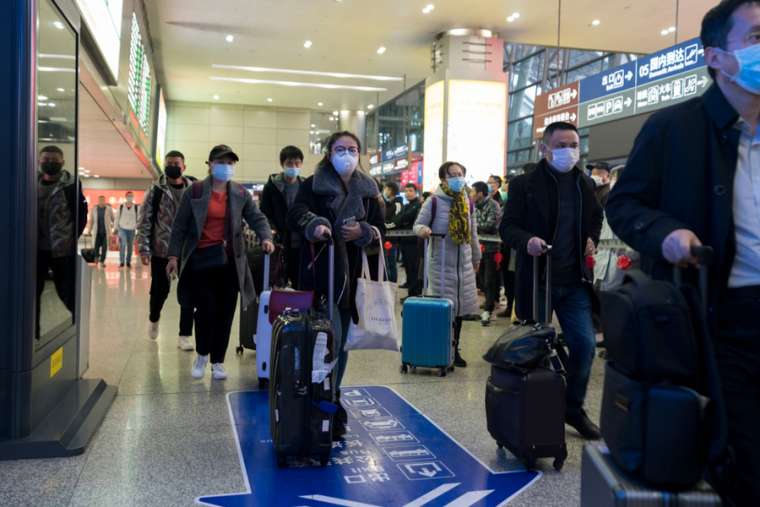 Travellers at an airport in Chengdu, China wear masks to prevent infection from coronavirus, Jan. 23, 2019. Credit: B.Zhou/Shutterstock.